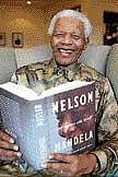 Nelson Mandela with a copy of his book Conversations with Myself. AP