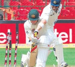 Beaten in flight: Indian skipper Mahendra Singh Dhoni whips off the bails to stump Australias Michael Clarke off Pragyan Ojha on the penultimate day of the second Test at the Chinnaswamy stadium on Tuesday. DH Photo/ Srikanta Sharma R