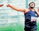 Armed to win: SBMJCs Abhishek Thimmaiah en route to winning the mens discus gold in 46th Bangalore University inter-collegiate athletics championship on Tuesday.DH Photo