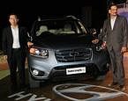 MD & CEO, Hyundai Motor India Ltd., H W Park and Director-Marketing & Sales, Hyndai Motor India Ltd., Arvind Saxena pose for photo with the company's new luxury SUV Santa Fe during its launch at a village in Jodhpur on Wednesday night. PTI