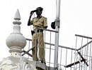 Tight vigil: A policeman keep a close watch on Vidhana Soudha premises during the second trust vote in Bangalore on Thursday. DH Photo
