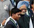 Pat on the Back: Prime Minister Manmohan Singh  congratulates CWG medal-winning gymnast Ashish Kumar. PTI