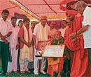 Honour: Udupi Pejawar Mutt Seer Sri Visveshatrhirtha  swamiji  being conferred with Cauvery award at the valedictory of navarathri puja celebrations and award distribution function organised at Baby Mutt in Pandavapura taluk on Monday. Chief Minister B S Yeddyurappa, Ministers Basavaraj Bommai, A Ramdas, Durdundeshwara mutt Seer Sri Trinethra  Mahantha Swamiji, Nagarajappa and others are seen. DH Photo