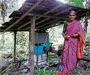 Appi wife of Manjappa Malekudiya near the power generation unit. DH Photo