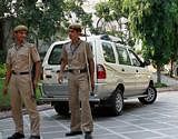 Delhi policemen stand guard at the residence of senior BJP leader Sudhanshu Mittal, whose relatives were allegedly given major contracts of the Commonwealth Games, in New Delhi on Tuesday. PTI