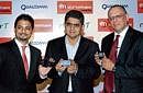 (From left) Micromax Informatics Ltd Business Director Vikas Jain, Qualcomm India Country Manager & Vice President (Business Development) Sandeep Sibal and Modu Chairman & CEO Dov Moran, pose with the 'Modu T', a 3.5G touch mobile phone, during its launch in New Delhi on Wednesday. PTI