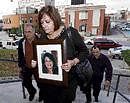 Roxanne Lloyd carries a picture of her daughter Jessica Lloyd as she arrives at a court in Belleville, Canada, on Tuesday. AP