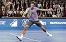 Milestone Man: Swiss Roger Federer essays a backhand return during his win over  American Taylor Dent in the Stockholm Open on Thursday. AFP