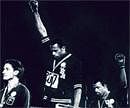 Black power salute: Tommie Smith (centre) and John Carlos (right) demonstrate their anger on the victory podium at the 1968 Olympic Games in Mexico.