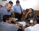 strategy session:  KSCA President Srikantadatta Narasimharaja Wadiyar, members of his panel and KSCA CEO M P Ganesh inspect documents found in the possession of a representative they claim was from Sporting Frontiers. dh Photo