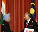 Prime Minister Manmohan Singh, left, shakes with his Malaysian counterpart Najib Razak after a joint press conference at the latter's office in Putrajaya, outside Kuala Lumpur, Malaysia on Wednesday. AP