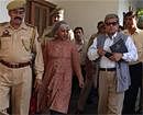 Interlocutors on Kashmir journalist Dileep Padgaonkar, right, and academician Radha Kumar, center, arrive escorted by security personnel at a guest house in Jammu on Wednesday. AP