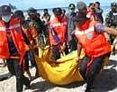 Rescuers carry the body of a tsunami victim on Pagai island, in Mentawai Islands, Indonesia, Thursday, Oct. 28, 2010.AP