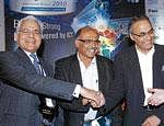 (L to R) NASSCOM Chairman Harsh Manglik, Deccan Charters Ltd CMD Capt G R Gopinath, Clsco System President, of Globalisation Anil Menon shake hands at the Vision 2020 leadership series at the Bangalore IT. BIZ on Friday. DH Photo