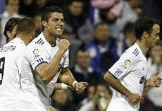 Real Madrid's Portuguese forward Cristiano Ronaldo (C) celebrates after scoring against Hercules during their Spanish League football match on October 30, 2010 at Rico Perez Stadium in Alicante. AFP