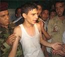 Iraqi security forces and wellwishers surround an Iraqi youth after his release from a hostage situation at the Sayidat al-Najat church where several worshippers were killed, following a rescue operation by Iraqi and US forces in Baghdad's Karrada neighbourhood on October 31, 2010. AFP