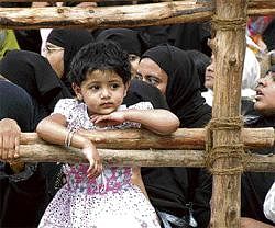 Roadblock: A child with Haj piligrims at Millers Road in Bangalore on Wednesday. DH photo
