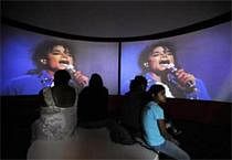 Visitors watch a video of a performance at the Michael Jackson exhibit in the Grammy Museum in Los Angeles. File photo Reuters