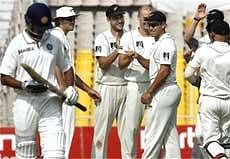 New Zealand players celebrate the dismissal of India's Rahul Dravid on the fourth day of their first Test match at Sardar Patel Stadium in Ahmedabad on Sunday. Also seen in the picture is Sehwag's batting partner Rahul Dravid. PTI