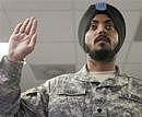 U.S. Army Spc. Simran Lamba, takes the oath of citizenship to become a naturalized citizen before his graduation from basic training at Fort Jackson, S.C., AP