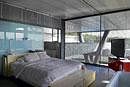 Experimentation: The master bedroom with access to the lap pool at back right. (Stefano Buonamici/The New York Times)