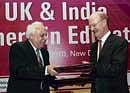 Balancing act: Human Resource Development Minister Kapil Sibal and UKs Minister for Universities and Sciences David Willetts exchange documents after signing an agreement for UKIERI (Phase II), in New Delhi on Friday. PTI