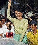 Aung San Suu Kyi waves to supporters in Yangon. AFP