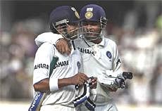 India's not out batsmen Virender Sehwag, right and Gautam Gambhir share a moment as they walk out of field after the second cricket test match against New Zealand ended in a draw in Hyderabad, India, Tuesday, Nov.16, 2010. AP