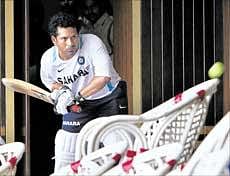 Batting maestro Sachin Tendulkar polishes his skills in the dressing room after rain hampered Indias practice session on Friday. AP