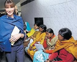 FINE GESTURE: French first lady and global AIDS ambassador Carla Bruni-Sarkozy,walks past patients as she visits the Naz Foundation care home for orphaned children with HIV/Aids inNewDelhi onMonday. AFP