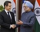 French President Nicolas Sarkozy, left, is greeted by Indian Prime Minister Manmohan Singh before their meeting at Hyderabad House in New Delhi on Monday. AP