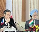 new bonhomie: French President Nicolas Sarkozy addresses a press conference with Prime Minister Manmohan Singh in New Delhi on Monday. AP