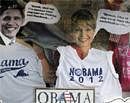 Cutouts of U.S. President Barack Obama (L) and former Alaska Governor Sarah Palin wear T-shirts in a shop window display in Edgartown, Massachusetts . Reuters File Photo