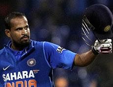 India's Yusuf Pathan raises his bat to celebrate scoring a century during their fourth one day international cricket match against New Zealand, in Bangalore. AP
