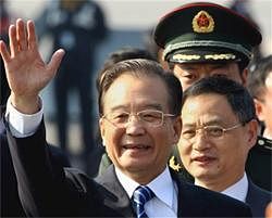 Chinese Premier Wen Jiabao waves on his arrival at Palam Airforce Station in New Delhi on Wednesday. PTI Photo