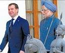 Russian President Dmitry Medvedev and Prime Minister Manmohan Singh arrive for a meeting in New Delhi on Tuesday. AFP