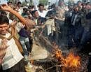 Bharatpur: Gujjars burn an effigy on a railway track disrupting rail traffic during their protest in Pilupura village in Bharatpur district of Rajasthan on Friday. PTI Photo