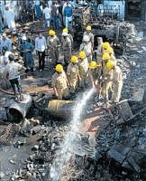 The fire personnel put out a blaze at the scrap yard in Mysore on Saturday. DH photo