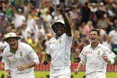 South Africa's fielder Lonwabo Tsotsobe, centre reacts with teammates Graeme Smith, left, and Dale Steyn, right, after taking a catch to dismiss India's batsman Vangipurappu Venkata Sai Laxman, unseen, on the first day of the second cricket test match at the Kingsmead stadium in Durban, South Africa. AP Photo