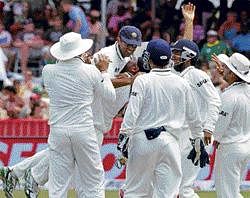 The Milestone Catch: Harbhajan Singh hugs Rahul Dravid (2nd left) after Dravid took a catch to dismiss South Africa's Dale Steyn at Durban on Monday. Reuters