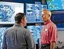 Phil Holmes, right, VP of the Magic Kingdom, at the parks underground control room. Disney uses the command centre to monitor rides around the park and control crowd size. Walt Disney World via The New York Times