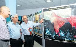 Karnataka State Remote-Sensing Applications Centre scientist Dr V Shreedhara explains a satellite picture to Rural Development and Panchayat Raj Department Principal Secretary P Ravi Kumar and National Remote-Sensing Centre  (Hyderabad) Director Dr V Jayaraman at an exhibition in Bangalore, on Tuesday. DH Photo