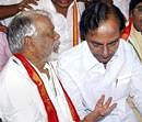 TRS President K. Chandra Sekhar Rao talks with Congress MP K Keshava Rao who, along with other party legilators, is staging an indefinite hunger strike demanding withdrawal of cases registered against students who participated in the Telangana movement, in Hyderabad on Tuesday. PTI