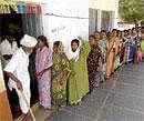 Exercising their right: Women wait to cast their votes at a polling station in Bhagyanagar village in Koppal district on Friday. DH Photo