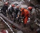 Rescue workers try to recover the body of a landslide victim in Nova Friburgo, Brazil, Saturday, After four nights of torrential rains, mudslides have killed more than 500 people in the Rio de Janeiro area. AP Photo