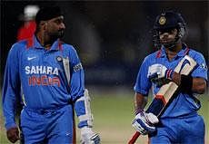 India's batsman Virat Kohli, right, with teammate Harbhajan Singh. AP Photo