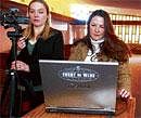 Irene Dahl, right, owner of Dahl Funeral Home, works with Stepanie Peterson to set up a web camera and laptop to webcast a funeral service, in Bozeman, Mont. NYT