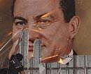 A demonstrator defaces a poster of Egyptian President Hosni Mubarak in Alexandria, Egypt, Tuesday. AP