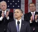 President Barack Obama is applauded by Vice President Joe Biden and House Speaker John Boehner on Capitol Hill in Washington. AP