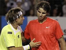 Spain's Rafael Nadal, talks with compatriot David Ferrer at the net after his quarterfinal loss to Ferrer at the Australian Open tennis championships in Melbourne in Australia on Wednesday. AFP